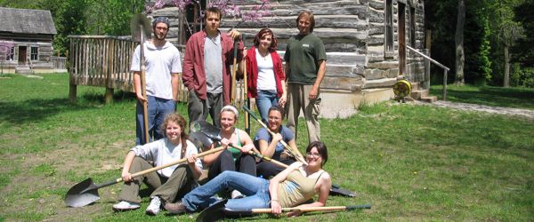 volunteer tree planters posing with shovels in hand